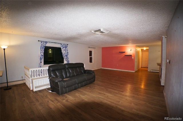 living room featuring a textured ceiling and dark hardwood / wood-style flooring