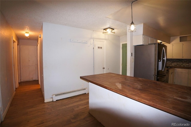 kitchen with tasteful backsplash, hanging light fixtures, a baseboard heating unit, dark wood-type flooring, and stainless steel fridge with ice dispenser