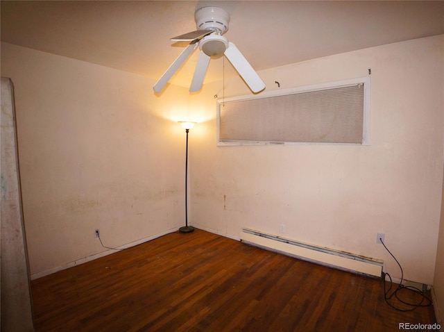 unfurnished room featuring a baseboard heating unit, dark hardwood / wood-style floors, and ceiling fan