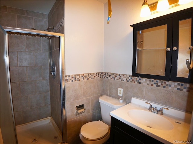 bathroom featuring tile walls, an enclosed shower, and toilet