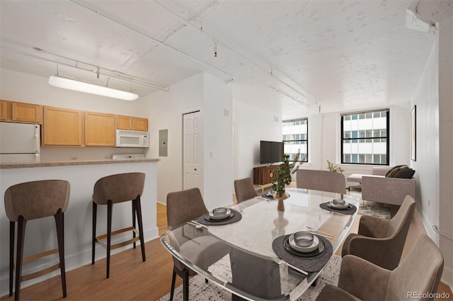 444 17th St Unit 802, Denver, CO 80202 - dining space featuring track lighting, light wood finished floors, and electric panel