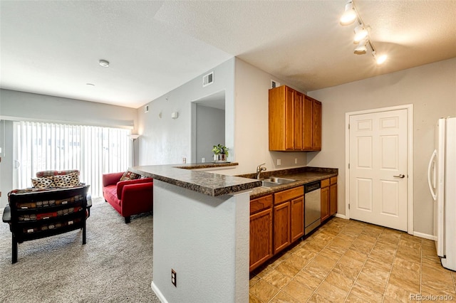 kitchen with white fridge, sink, light tile floors, and a textured ceiling