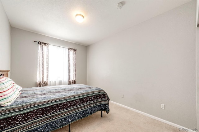 bedroom featuring light colored carpet