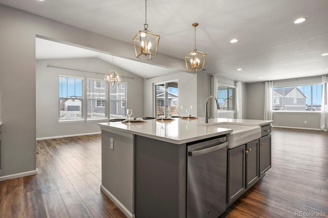 kitchen featuring a sink, dark wood-style floors, light countertops, dishwasher, and an island with sink