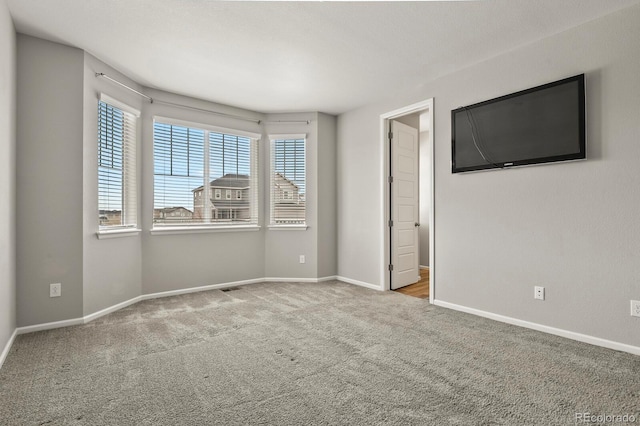 unfurnished bedroom featuring carpet, visible vents, and baseboards