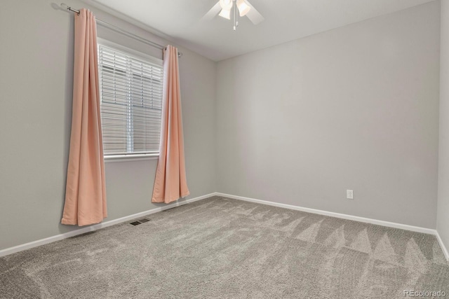 unfurnished room with a ceiling fan, carpet flooring, visible vents, and baseboards