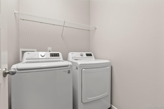 washroom featuring laundry area and washer and dryer