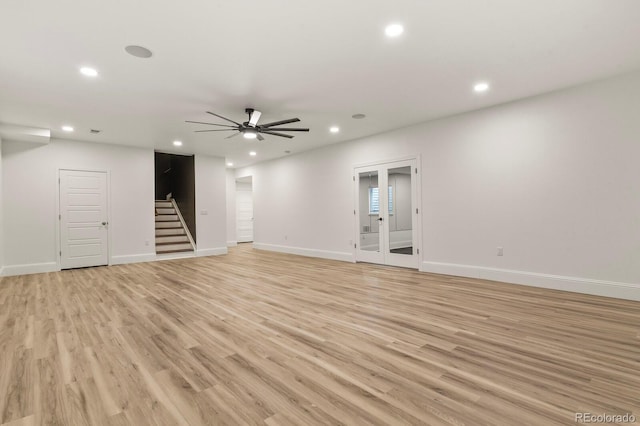 unfurnished room with stairs, light wood-type flooring, baseboards, and recessed lighting