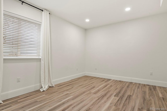 unfurnished room with recessed lighting, baseboards, and light wood finished floors