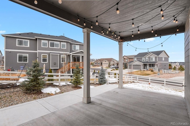 view of patio / terrace with a residential view and fence