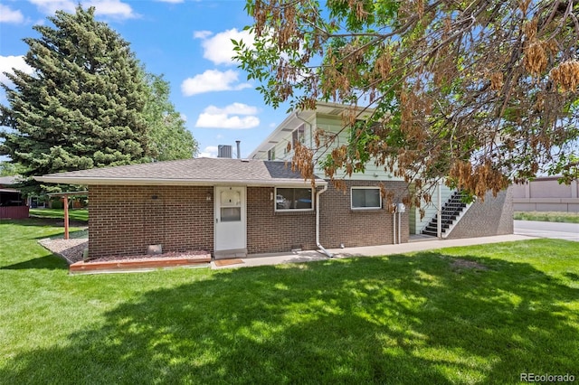 3631 W 79th Ave Unit A2, Westminster, CO 80030 - rear view of house with a yard and brick siding