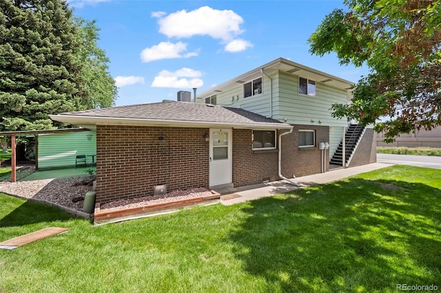 3631 W 79th Ave Unit A2, Westminster, CO 80030 - back of property featuring brick siding, a lawn, and stairway