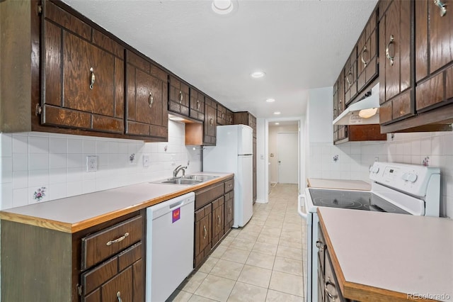 3631 W 79th Ave Unit A2, Westminster, CO 80030 - kitchen featuring white appliances, decorative backsplash, under cabinet range hood, dark brown cabinets, and light tile patterned floors