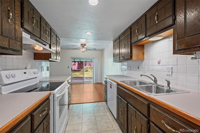3631 W 79th Ave Unit A2, Westminster, CO 80030 - kitchen with white appliances, under cabinet range hood, ceiling fan, light tile patterned floors, and decorative backsplash
