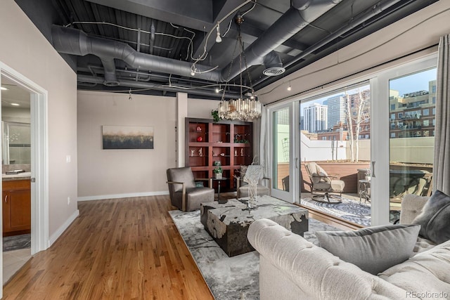 living area featuring baseboards and wood finished floors