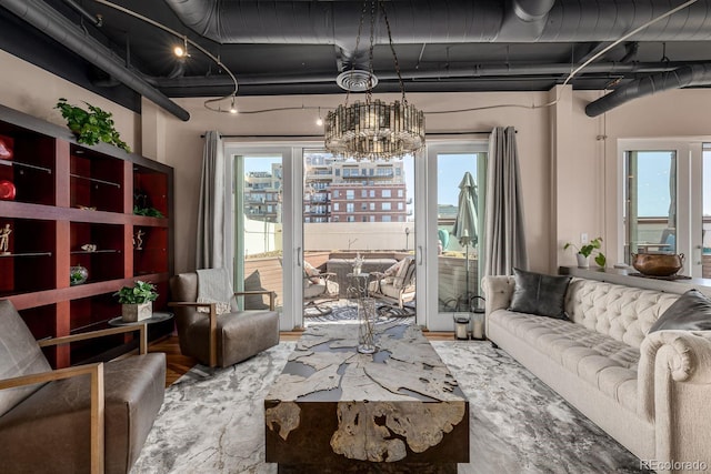 living area featuring wood finished floors and an inviting chandelier