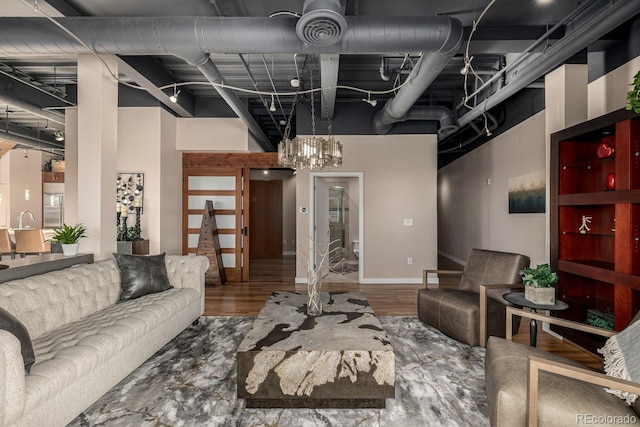 living room featuring a towering ceiling and wood finished floors