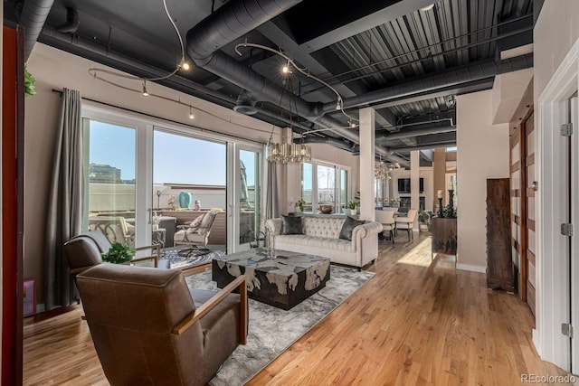 living room with a chandelier and wood finished floors