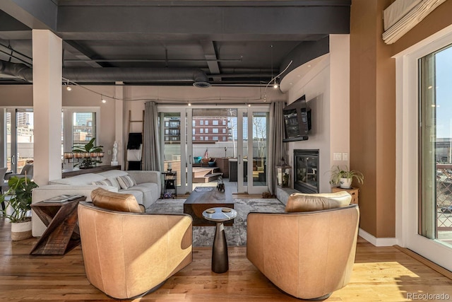 interior space featuring a healthy amount of sunlight, baseboards, and wood finished floors