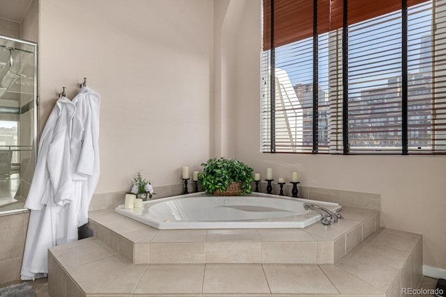 bathroom featuring a bath and a shower with shower door