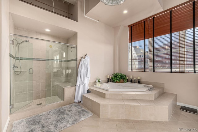 full bath featuring a shower stall, baseboards, a garden tub, and tile patterned floors