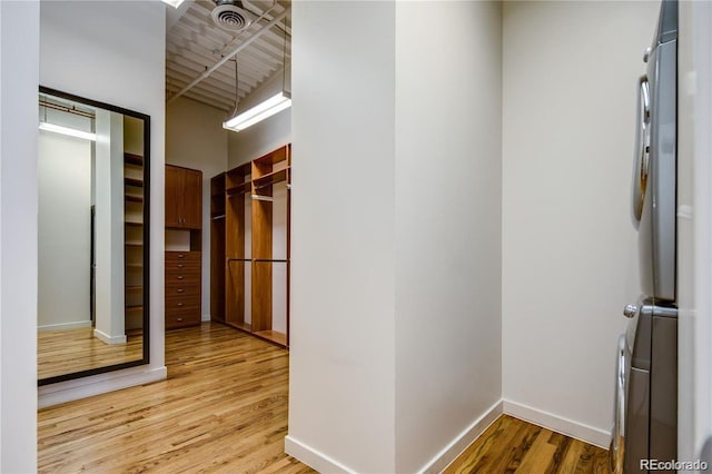 spacious closet with light wood-type flooring and visible vents