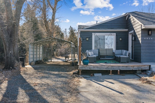 exterior space with an outdoor living space, a carport, and a deck