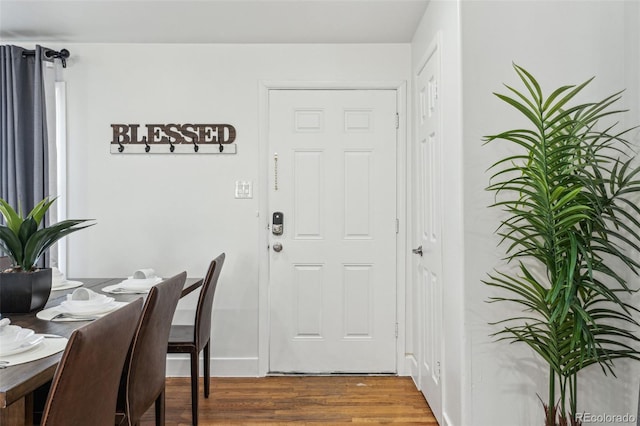 dining space with dark hardwood / wood-style flooring