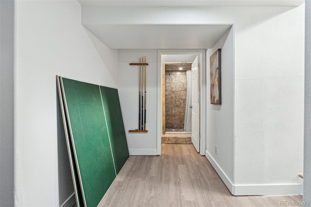 hallway with hardwood / wood-style flooring