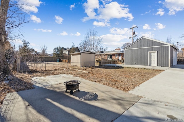 view of yard with an outdoor fire pit and a shed