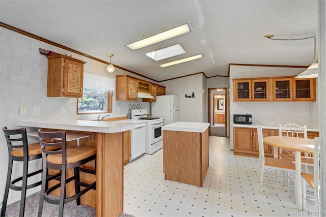 1360 Kiowa Rd, Florissant, CO 80816 - kitchen featuring white appliances, ornamental molding, lofted ceiling, a peninsula, and light countertops