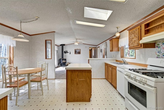 1360 Kiowa Rd, Florissant, CO 80816 - kitchen with white appliances, a wood stove, crown molding, a center island, and light flooring
