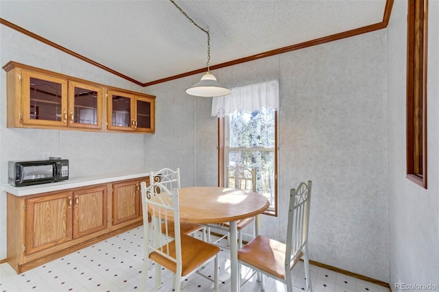 1360 Kiowa Rd, Florissant, CO 80816 - dining area with crown molding, light flooring, vaulted ceiling, and a textured ceiling