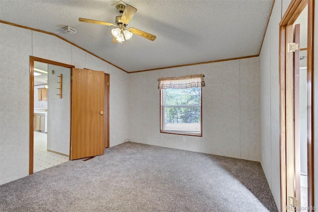1360 Kiowa Rd, Florissant, CO 80816 - unfurnished bedroom with ornamental molding, carpet, vaulted ceiling, a textured ceiling, and ceiling fan