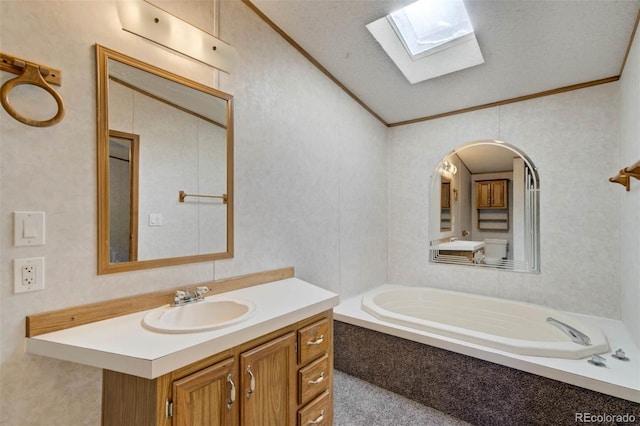 1360 Kiowa Rd, Florissant, CO 80816 - bathroom with a skylight, crown molding, vanity, vaulted ceiling, and a garden tub