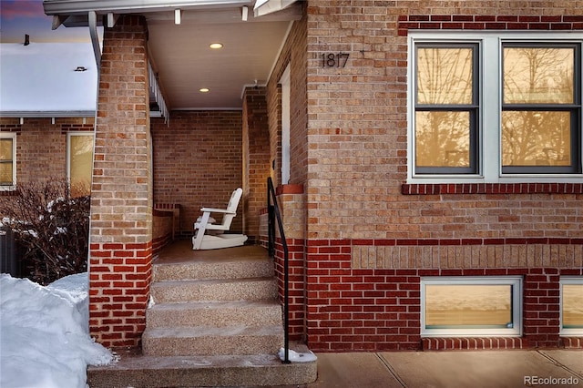 stairway featuring recessed lighting, brick wall, and wood finished floors