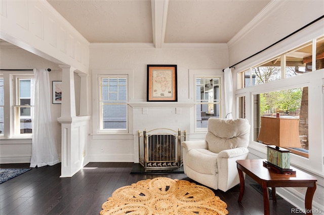 260 N Grant St, Denver, CO 80203 - living area featuring dark wood finished floors, decorative columns, beam ceiling, a fireplace, and crown molding