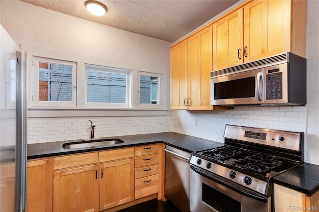 260 N Grant St, Denver, CO 80203 - kitchen featuring stainless steel appliances, a sink, dark countertops, tasteful backsplash, and a textured ceiling