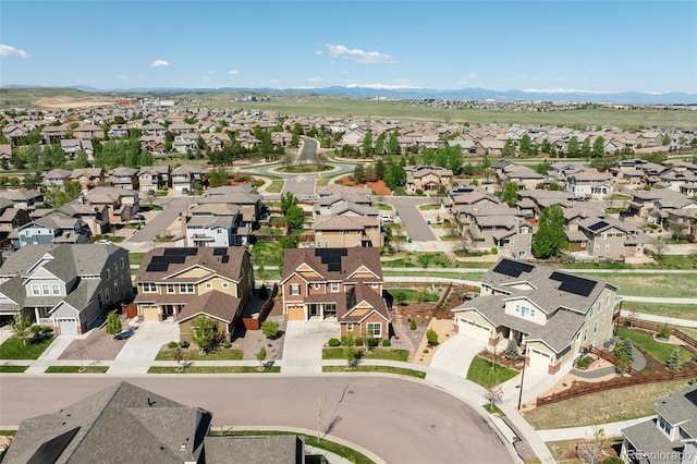 aerial overview of property's location featuring nearby suburban area and a mountainous background