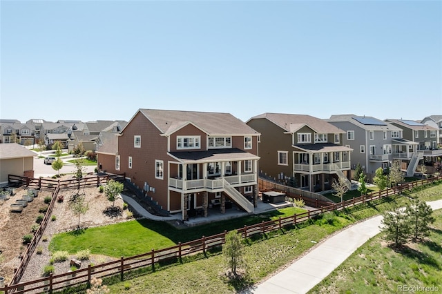 rear view of property featuring a residential view, a fenced backyard, and stairs