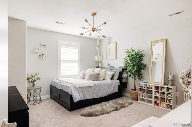 carpeted bedroom with a chandelier and baseboards