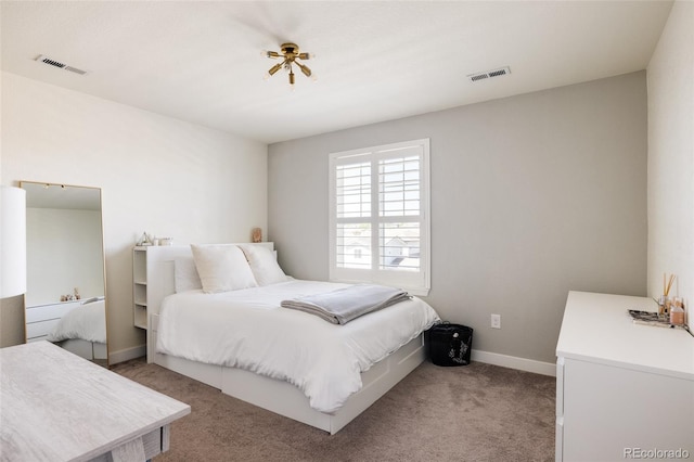 bedroom featuring light carpet and baseboards