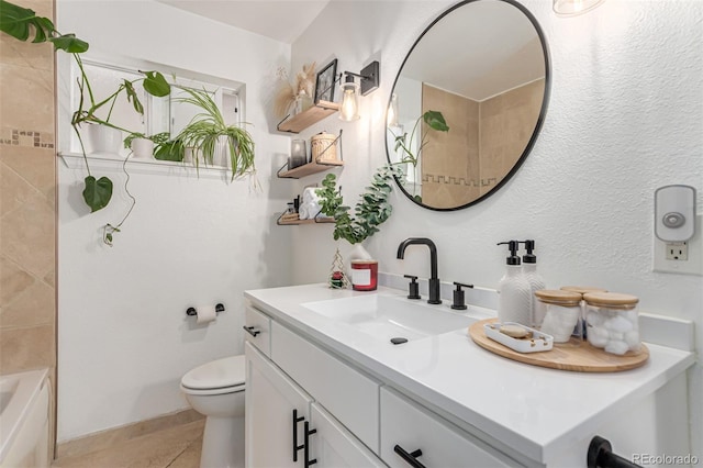 bathroom featuring vanity, toilet, and tile patterned flooring