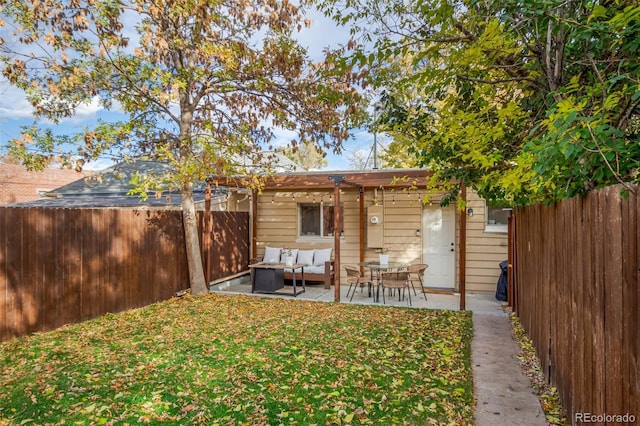 back of property featuring a yard, outdoor lounge area, and a patio area