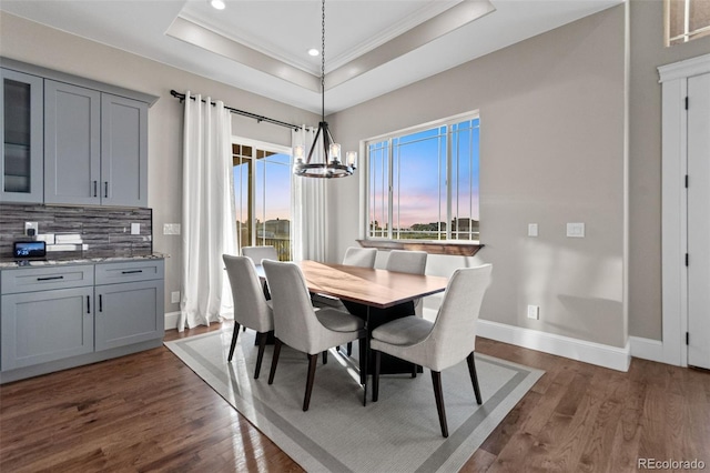 29303 E 165th Ave, Brighton, CO 80603 - dining space with ornamental molding, a tray ceiling, dark wood-style flooring, a chandelier, and recessed lighting