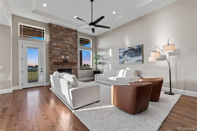 29303 E 165th Ave, Brighton, CO 80603 - living room with wood finished floors, recessed lighting, ceiling fan, and a stone fireplace