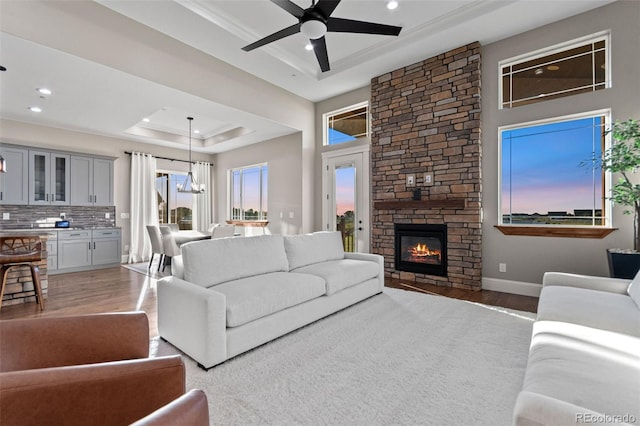 29303 E 165th Ave, Brighton, CO 80603 - living area featuring a tray ceiling, wood finished floors, healthy amount of natural light, ceiling fan, and recessed lighting
