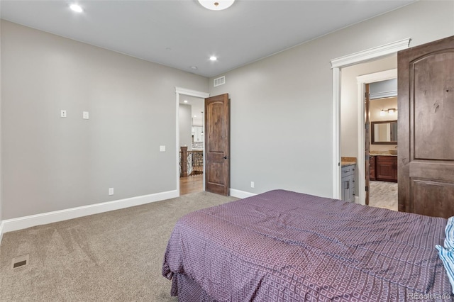 29303 E 165th Ave, Brighton, CO 80603 - bedroom with light carpet, recessed lighting, and ensuite bathroom