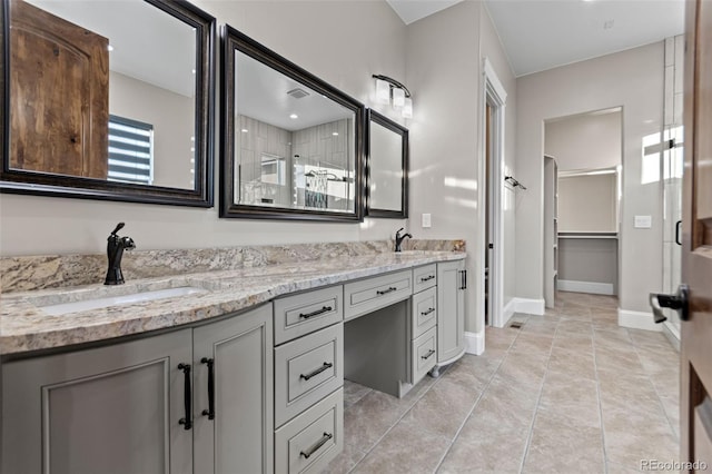 29303 E 165th Ave, Brighton, CO 80603 - full bathroom featuring double vanity, a shower, and a spacious closet