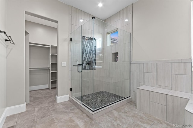 29303 E 165th Ave, Brighton, CO 80603 - bathroom featuring a shower stall, a walk in closet, tile patterned floors, and recessed lighting